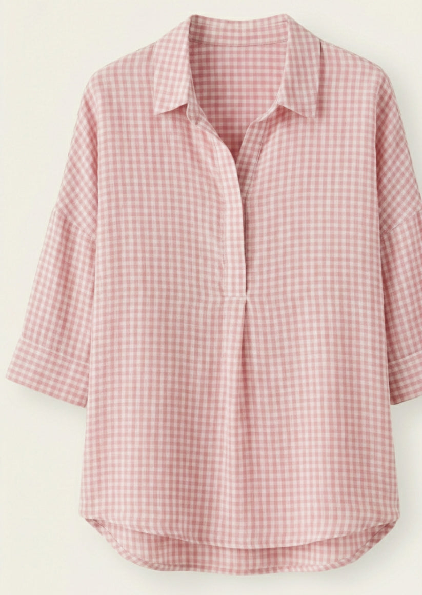 Pink and white checkered shirt on a light beige background