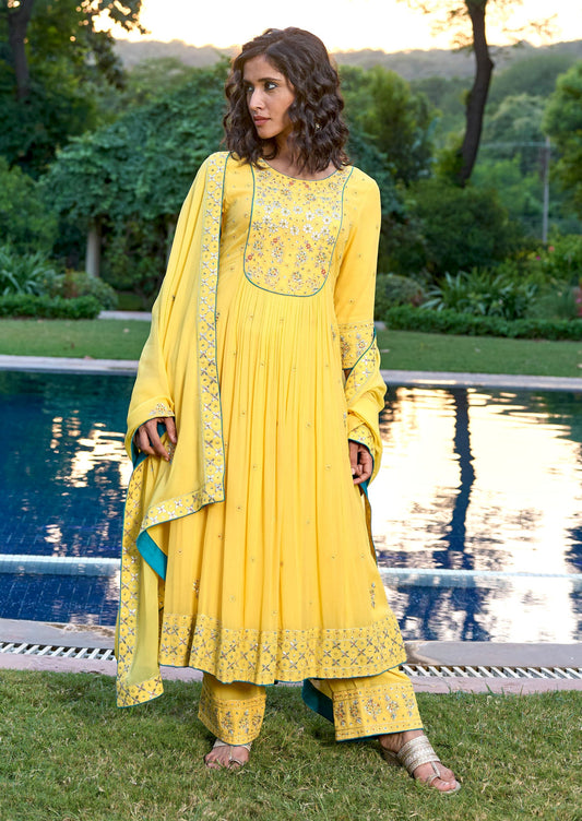 A stunning yellow Anarkali dress by Bbaawri, featuring intricate embroidery and a flowing silhouette. The vibrant yellow color adds a touch of elegance and grace to the traditional Anarkali design, making it a perfect choice for special occasions and festivities."