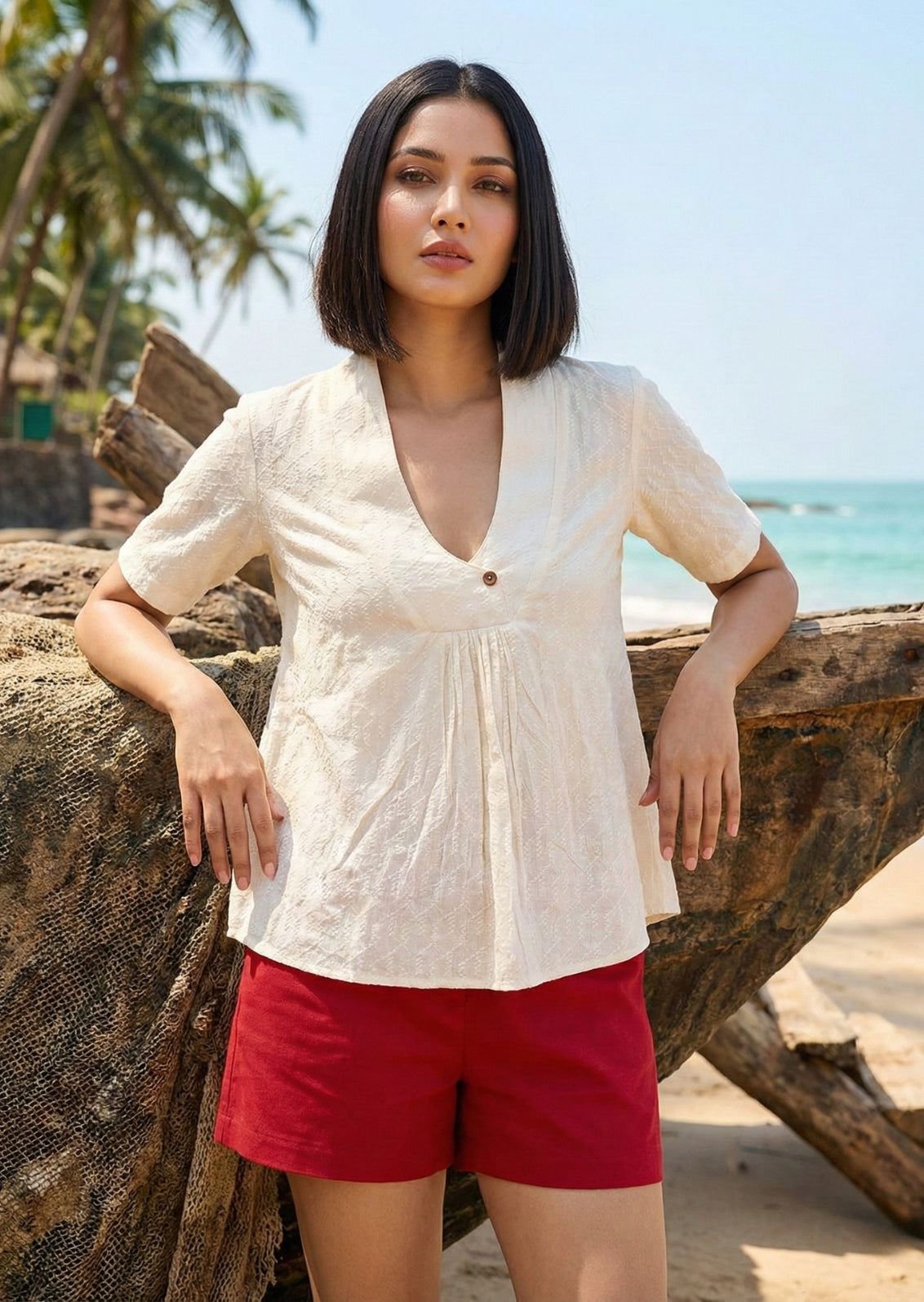 A hand-textured Dobby shirt in natural Kora cotton, featuring a minimalist V-neck and wooden button. Artisan-made luxury by Bbaawri.