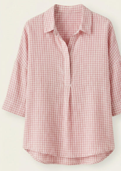 Pink and white checkered shirt on a light beige background