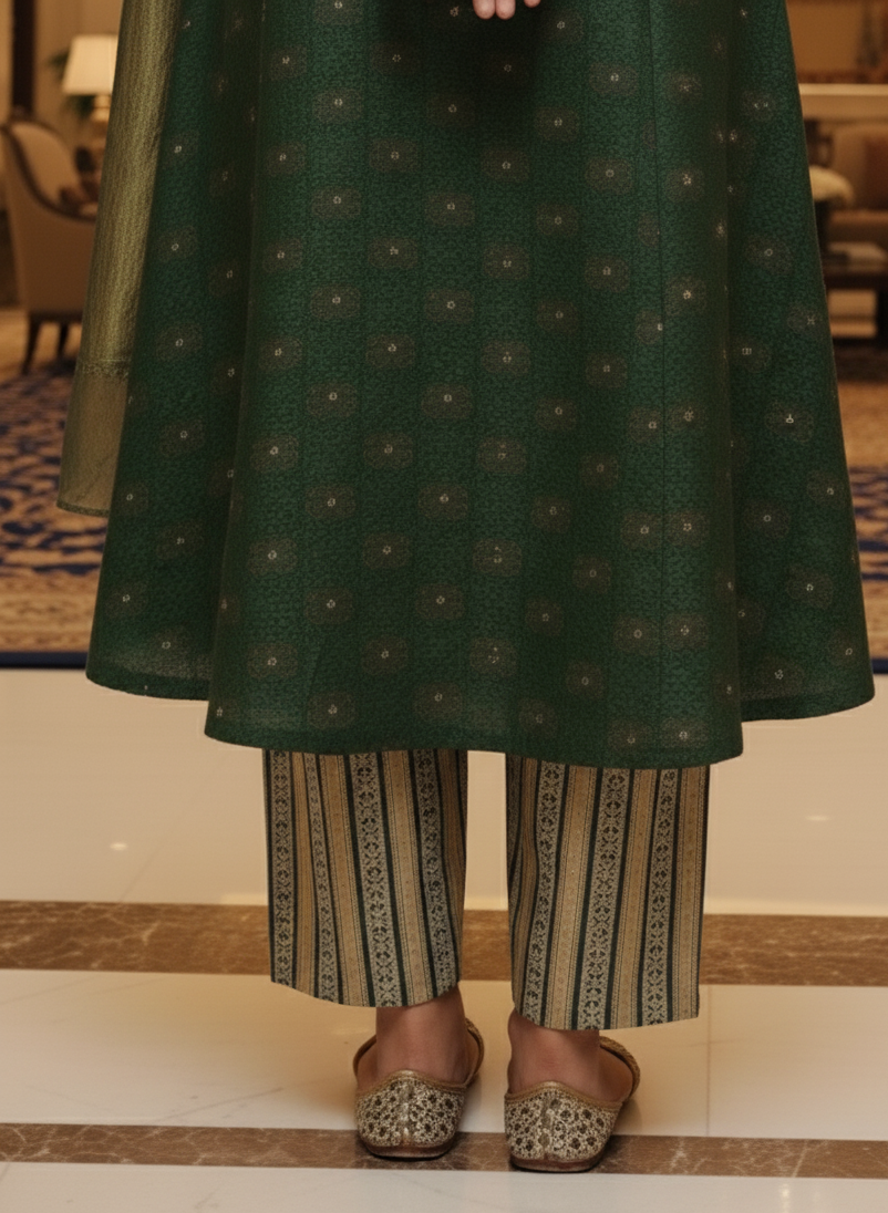 Person wearing a green patterned outfit with striped pants in an indoor setting.