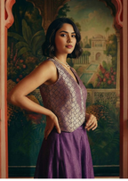 Close up of gold geometric pattern on purple brocade Indo-western top.
